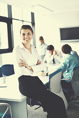 Image showing business woman with her staff in background at office