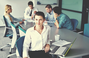 Image showing business woman with her staff in background at office