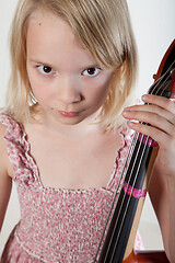 Image showing Portrait of a young teenager girl in studio with a cello