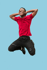 Image showing Freedom in moving and forward motion. The happy surprised young afro man jumping