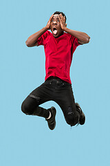 Image showing The young attractive man looking suprised in Jumping