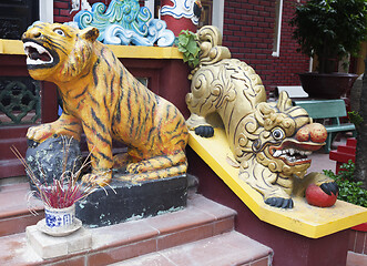 Image showing Tiger and lion statues at the entrance of a temple