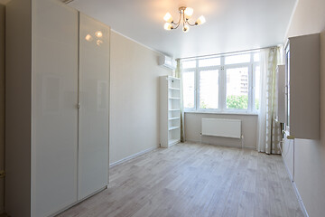 Image showing Room interior with wardrobe and hanging cupboards