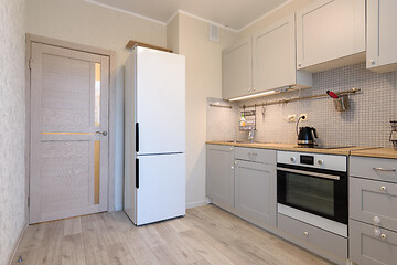 Image showing The interior of a small cozy kitchen in the apartment, the interior door to the kitchen is closed