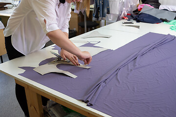 Image showing cutting the matter on a large table in the workshop