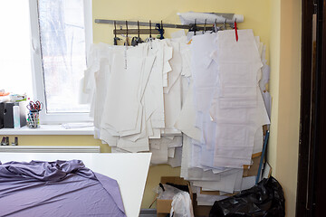 Image showing a lot of patterns hang on the wall in the sewing workshop