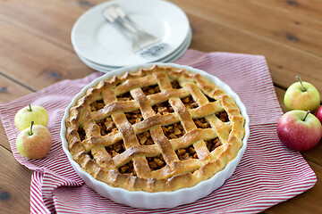 Image showing apple pie in baking mold on wooden table