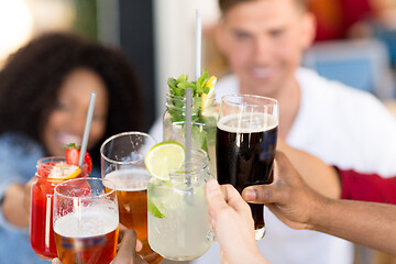 Image showing friends clinking glasses at bar or restaurant