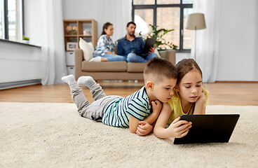 Image showing brother and sister with tablet computer at home
