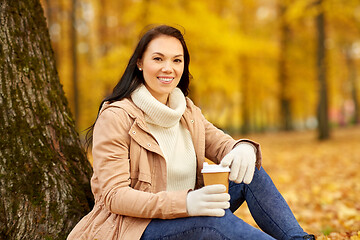 Image showing woman drinking takeaway coffee in autumn park