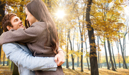 Image showing smiling couple hugging in autumn park