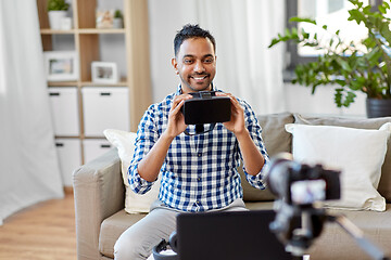 Image showing male blogger with vr glasses videoblogging at home