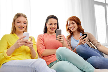 Image showing three teenage girls with smartphones at home