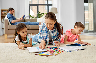 Image showing mother spending time with little daughters at home