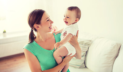 Image showing happy young mother with little baby at home