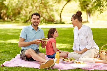 Image showing happy family having picnic at summer park