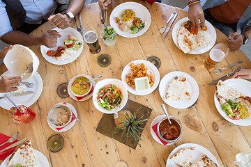 Image showing african american friends eating at restaurant