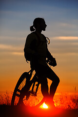 Image showing silhouette of the cyclist riding a road bike at sunset