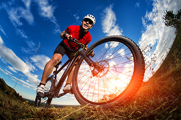 Image showing cyclist riding a bike on nature trail in the mountains.