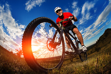 Image showing cyclist riding a bike on nature trail in the mountains.