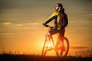 Image showing silhouette of the cyclist riding a road bike at sunset