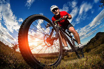 Image showing cyclist riding a bike on nature trail in the mountains.