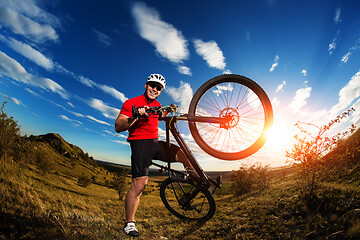 Image showing Low angle view of man riding bicycle against sky