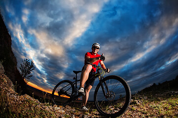 Image showing cyclist riding a bike on nature trail in the mountains.