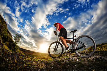 Image showing cyclist riding a bike on nature trail in the mountains.