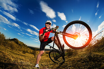 Image showing Low angle view of man riding bicycle against sky
