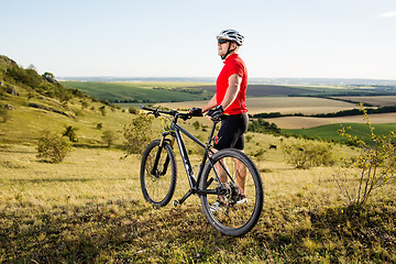 Image showing Low angle view of man riding bicycle against sky