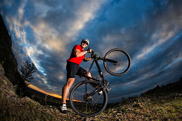 Image showing cyclist riding a bike on nature trail in the mountains.