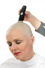 Image showing beautiful iddle age woman cancer patient shaving hair