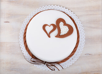 Image showing valentine love cake with hearts on wooden background