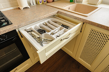 Image showing open kitchen drawer with silverware inside