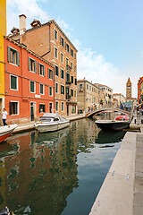Image showing Venice, Italy. Tourists walking at sidewalks aside to canals in historic part of the city