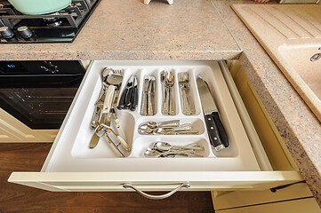 Image showing open kitchen drawer with silverware inside