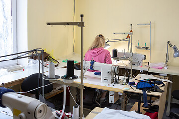 Image showing a room with sewing equipment and one female employee