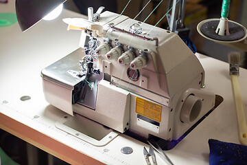 Image showing a industrial sewing equipment with many threads