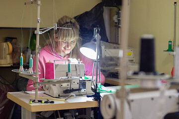 Image showing Garment worker works for an industrial sewing machine