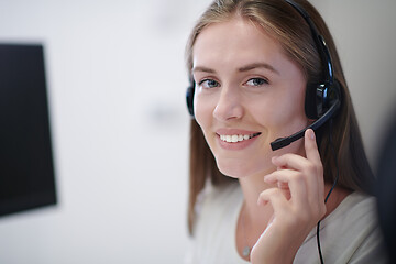 Image showing Business woman with headsets at work
