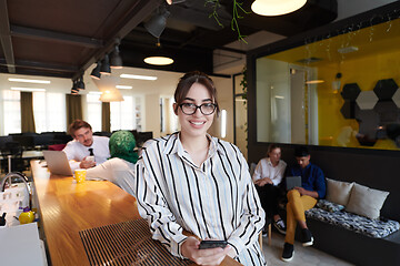 Image showing portrait of businesswoman with glasses using mobile phone