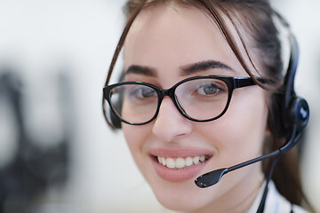 Image showing Business woman with headsets at work