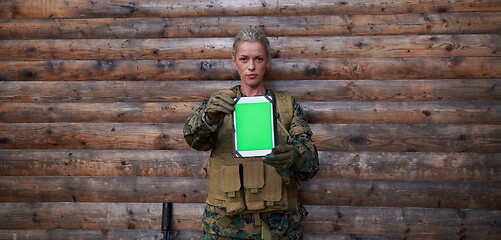 Image showing woman soldier using tablet computer