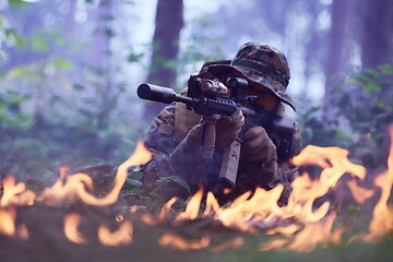 Image showing soldier in action aiming  on weapon  laser sight optics