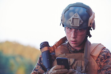 Image showing soldier using smart phone