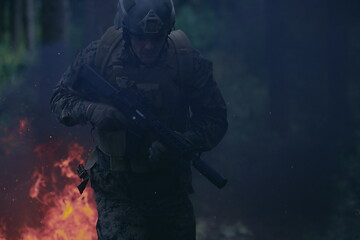 Image showing Soldier in Action at Night jumping over fire