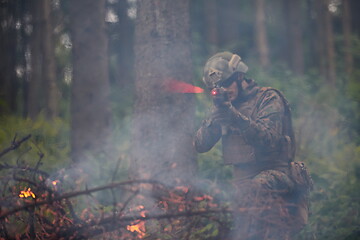 Image showing soldier in action aiming  on weapon  laser sight optics