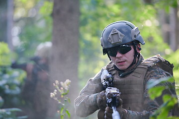 Image showing soldier in action aiming  on weapon  laser sight optics