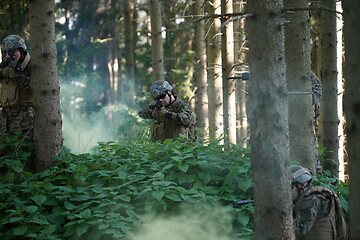 Image showing soldier in action aiming  on laser sight optics